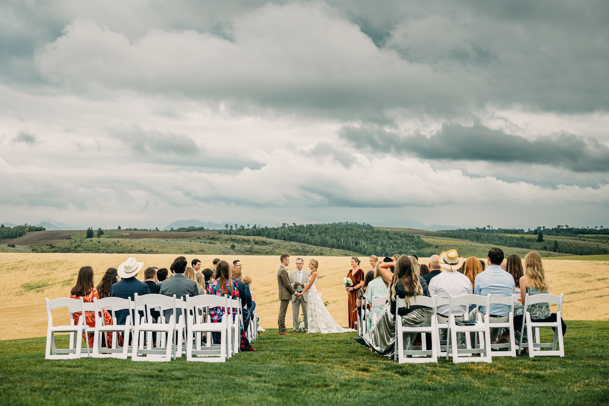 Western wedding with rainy clouds and mountain background, Driggs wedding venue and inspiration