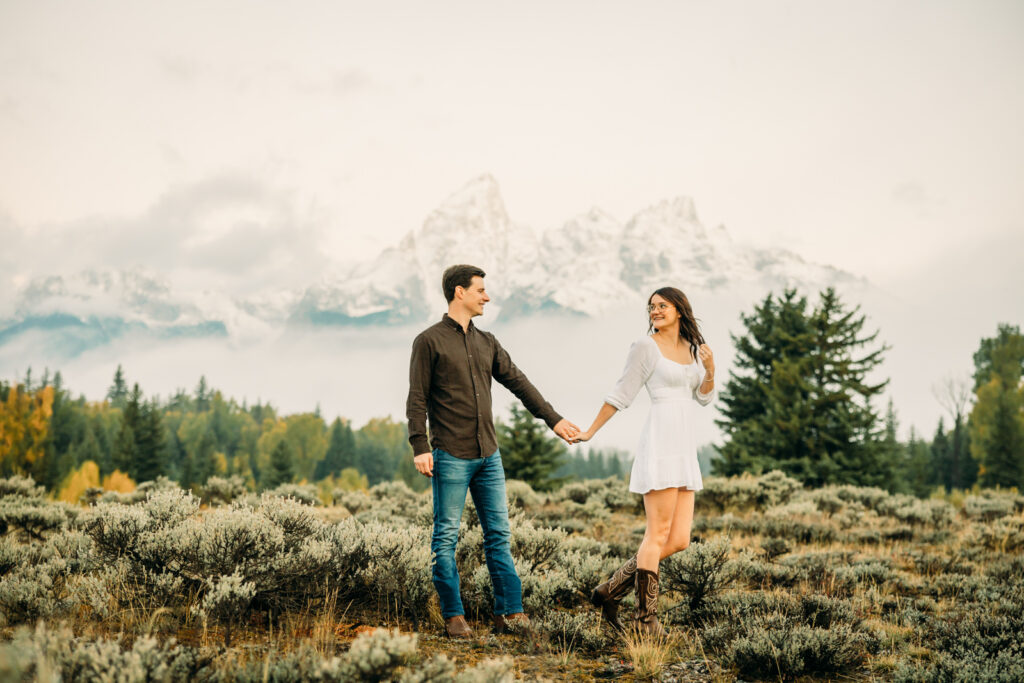 GTNP Schwabacher's Landing Engagement Couple newly proposed to with misty Teton mountain range, white dress