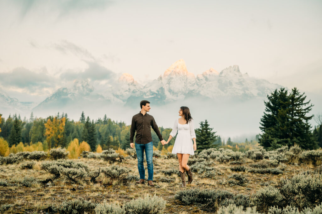 GTNP Schwabacher's Landing Engagement Couple newly proposed to with misty Teton mountain range, white dress