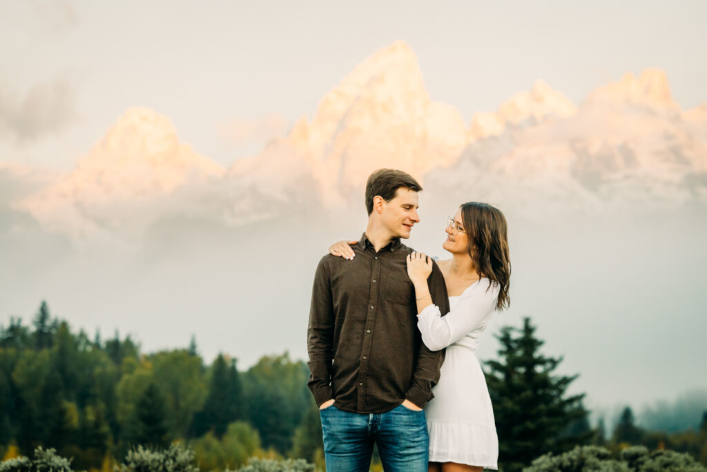 GTNP Schwabacher's Landing Engagement Couple newly proposed to with misty Teton mountain range, white dress