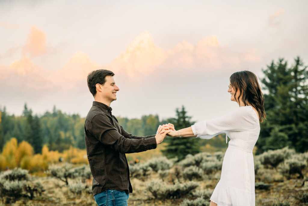 GTNP Schwabacher's Landing Engagement Couple newly proposed to with misty Teton mountain range, white dress