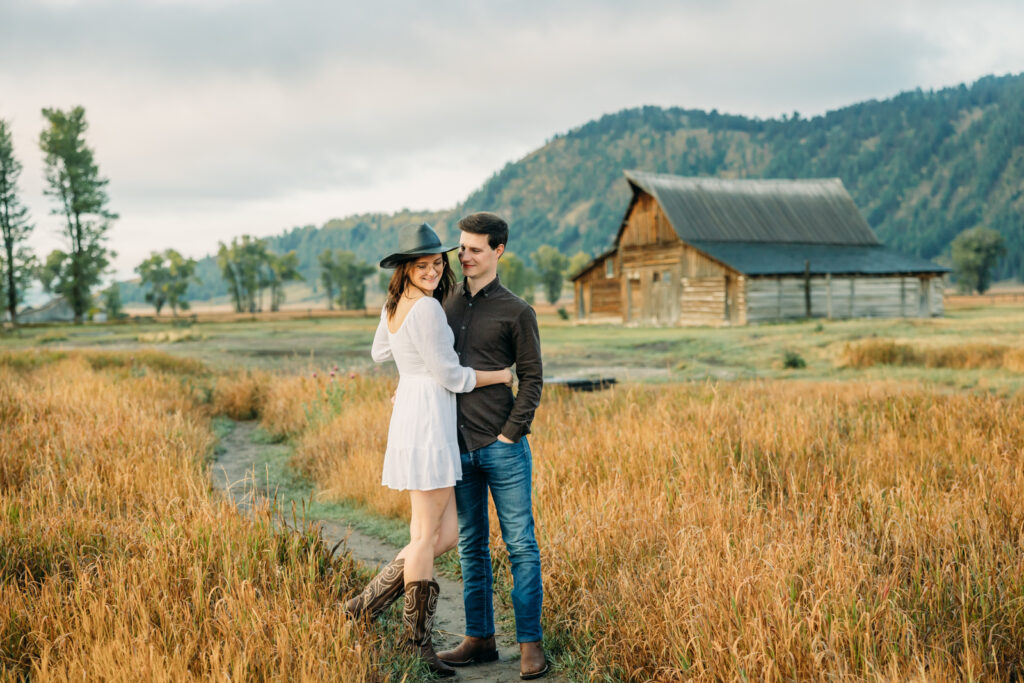 Mormon Row proposal with engaged couple in Grand Teton National Park fall morning photo session white clothes