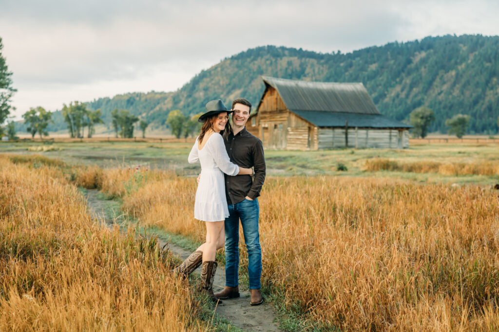 Mormon Row proposal with engaged couple in Grand Teton National Park fall morning photo session white clothes