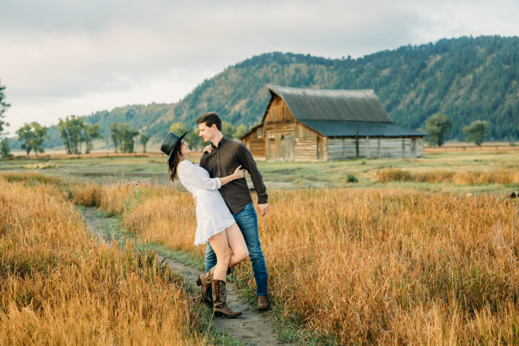 Mormon Row proposal with engaged couple in Grand Teton National Park fall morning photo session white clothes