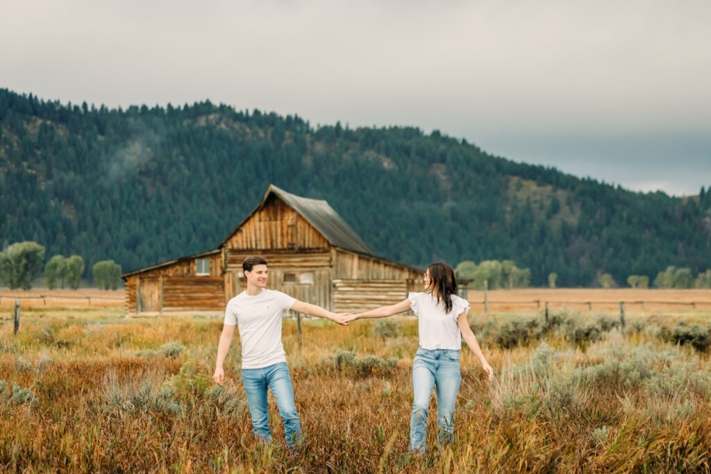 Mormon Row proposal with engaged couple in Grand Teton National Park fall morning photo session white clothes