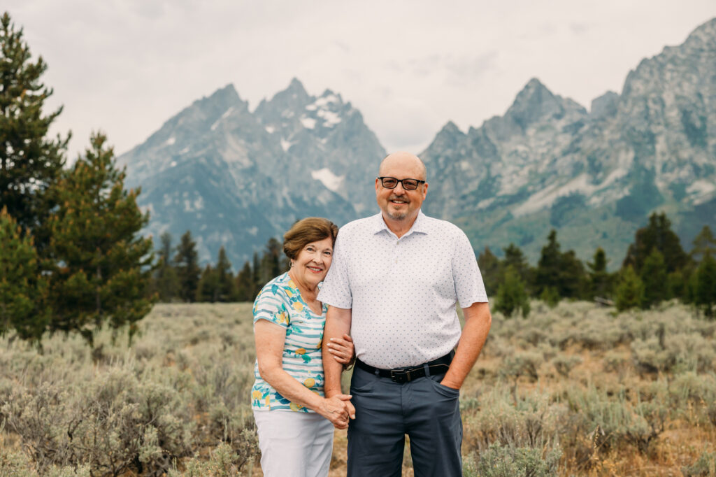 Extended family portrait with Grand Teton mountains at Cathedral Group Turnout