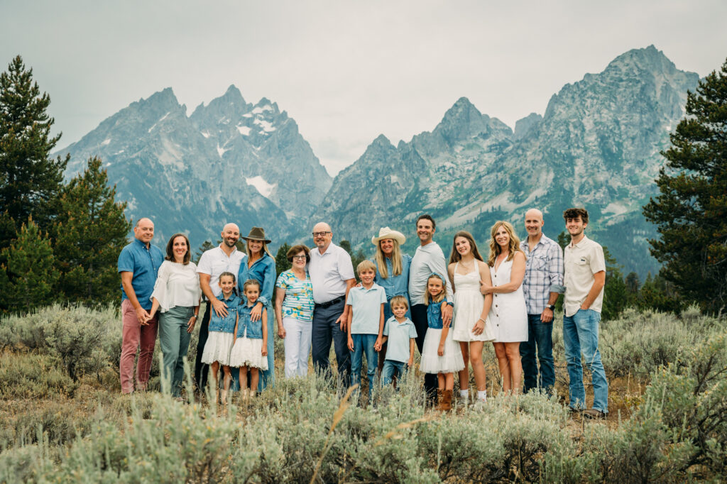 Extended family portrait with Grand Teton mountains at Cathedral Group Turnout