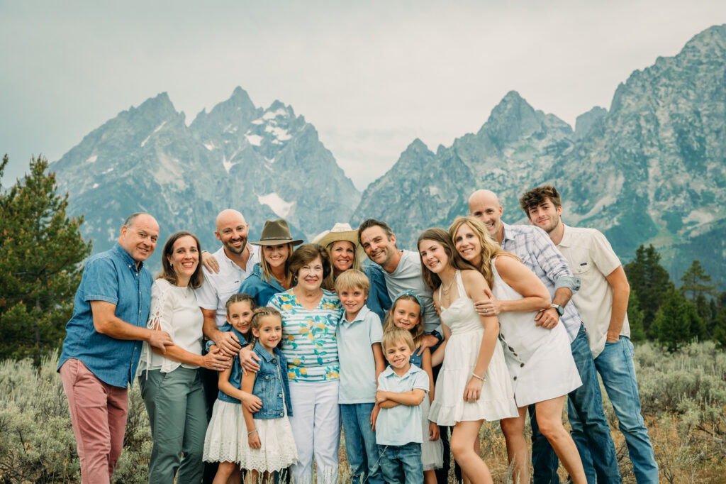 Family portrait with Grand Teton mountains at Cathedral Group Turnout