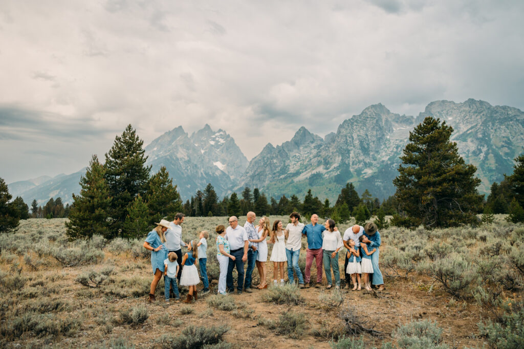 Extended family portrait with Grand Teton mountains at Cathedral Group Turnout