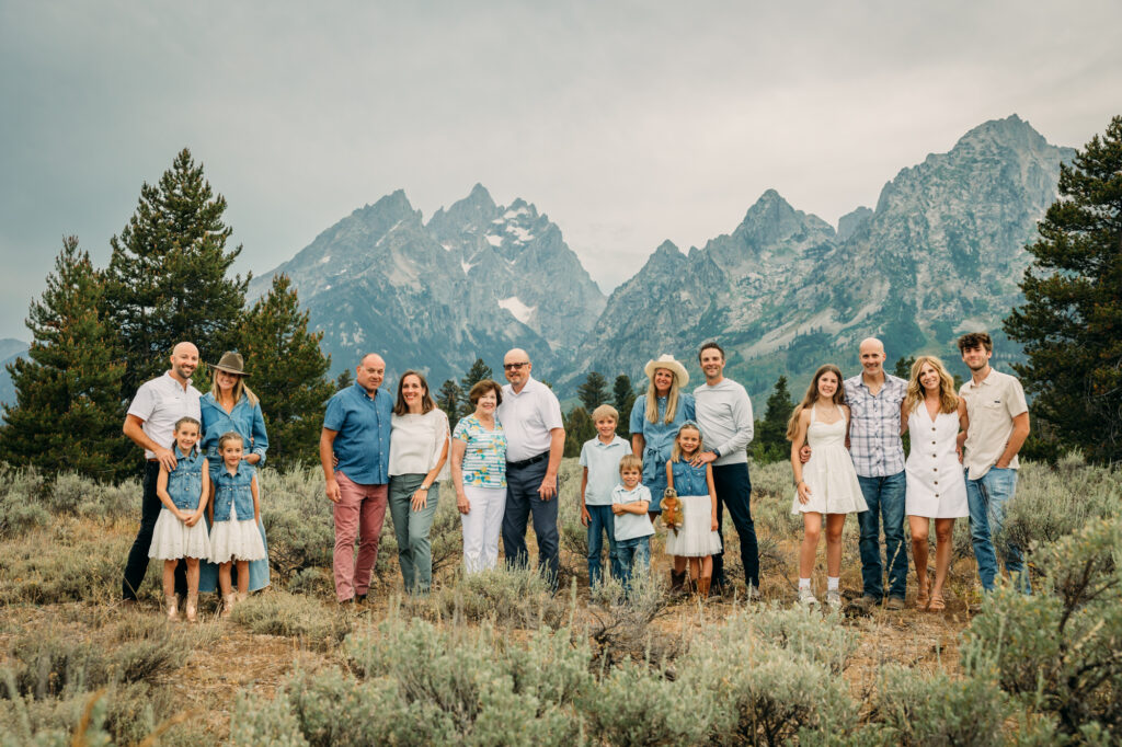 Family portrait with Grand Teton mountains at Cathedral Group Turnout