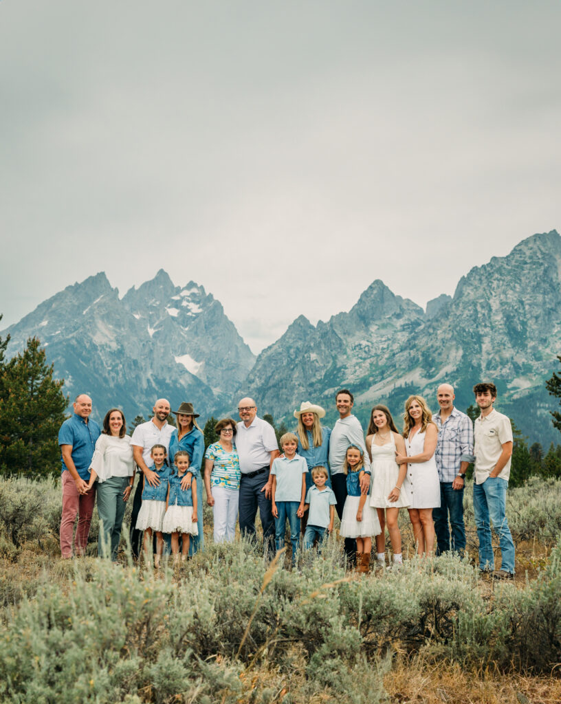 Family portrait with Grand Teton mountains at Cathedral Group Turnout