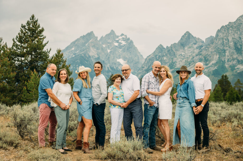 Extended family portrait with Grand Teton mountains at Cathedral Group Turnout