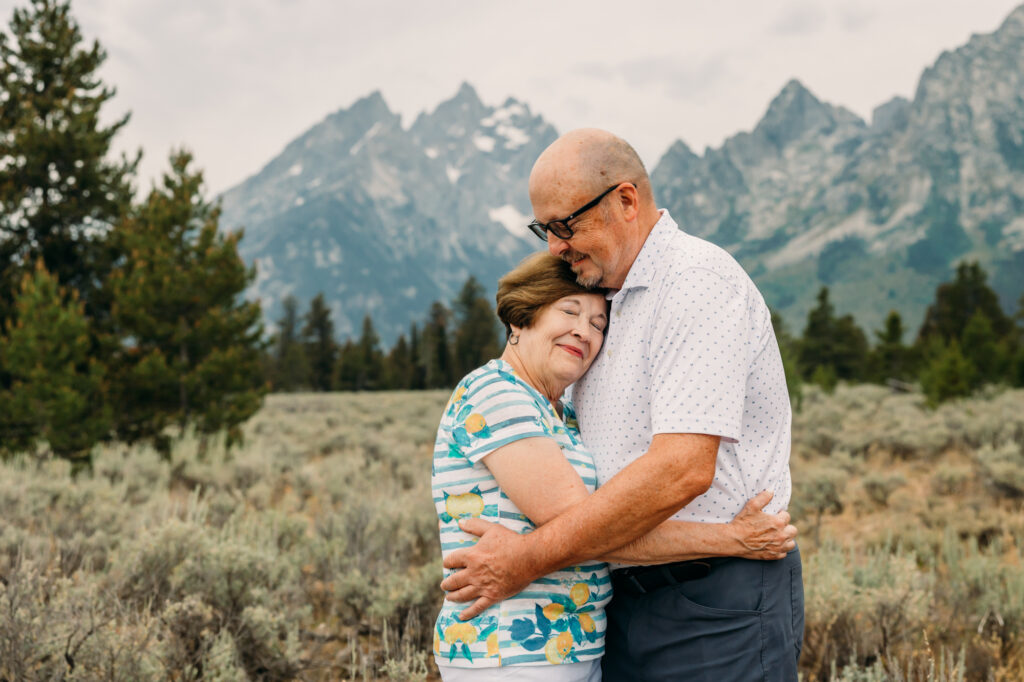 Extended family portrait with Grand Teton mountains at Cathedral Group Turnout