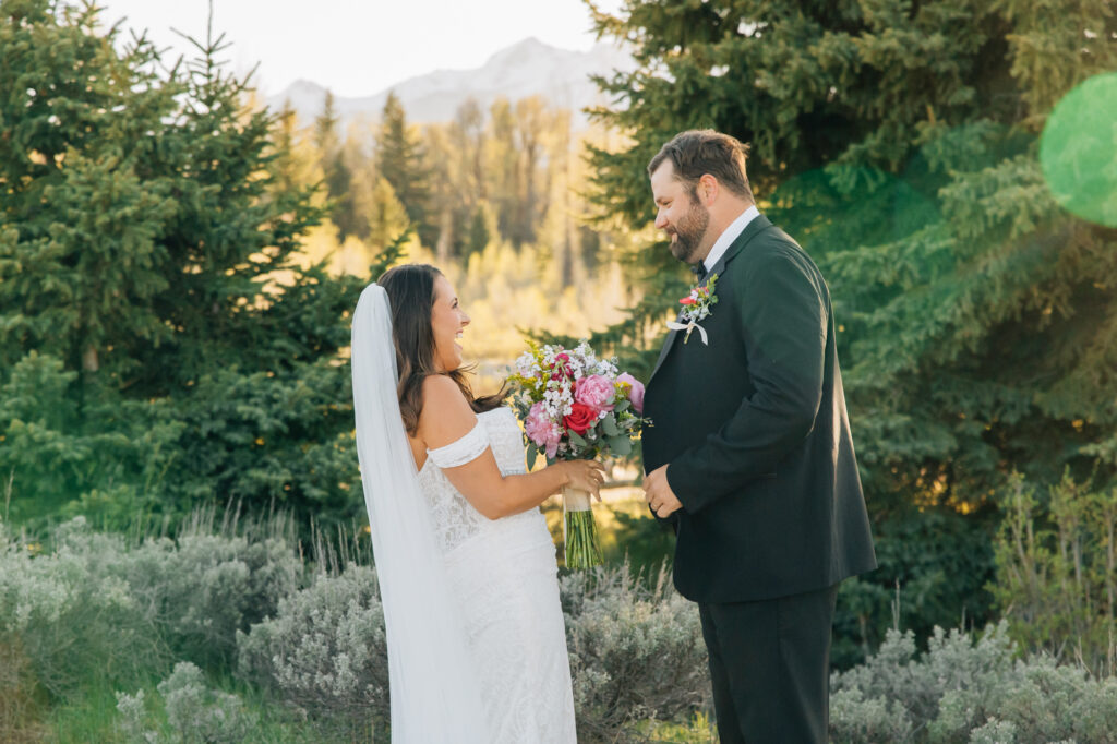 Schwabacher's Landing first look couple wedding photography with Snake River at sunset spring couple posing