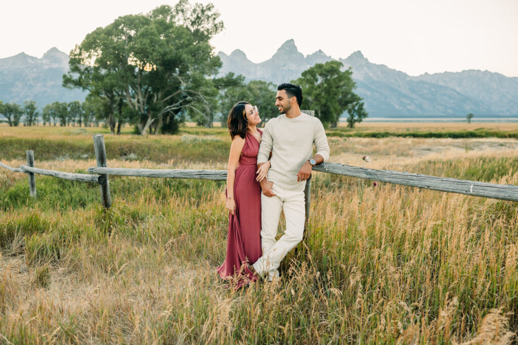 Couple Poses for Grand Teton Engagement Photo Session, playful couple by Mormon Row TA Moulton Barn