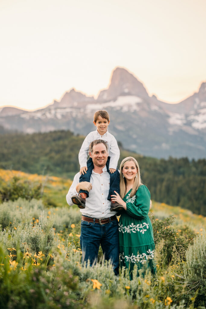 Grand Teton National Park family photographer capturing soft morning light over the mountains and a joyful family.