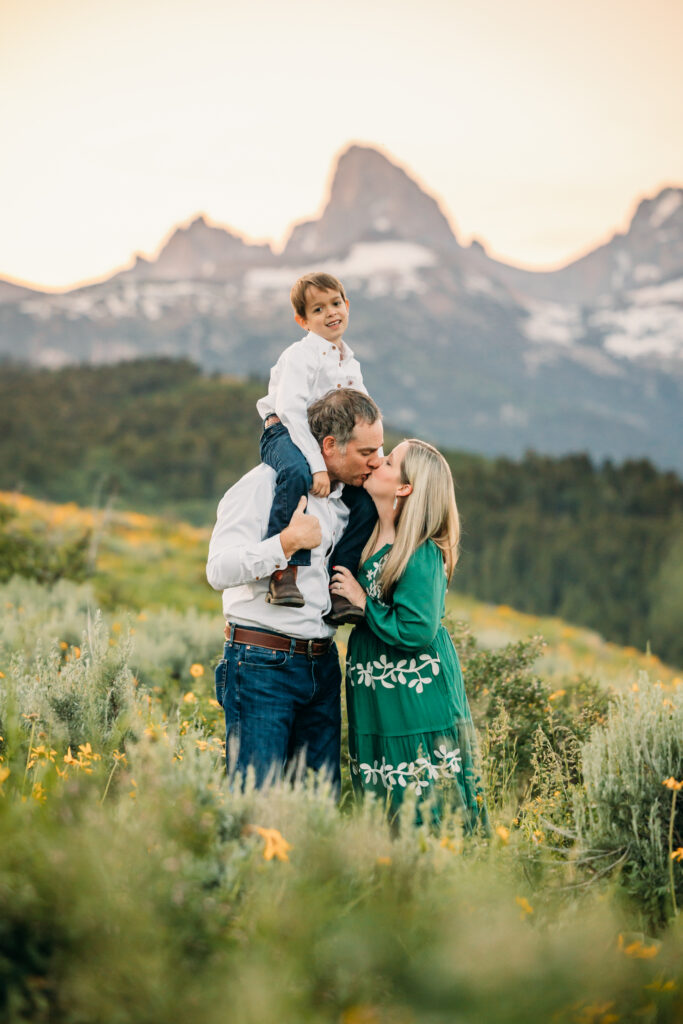 Grand Teton National Park family photographer capturing soft morning light over the mountains and a joyful family.