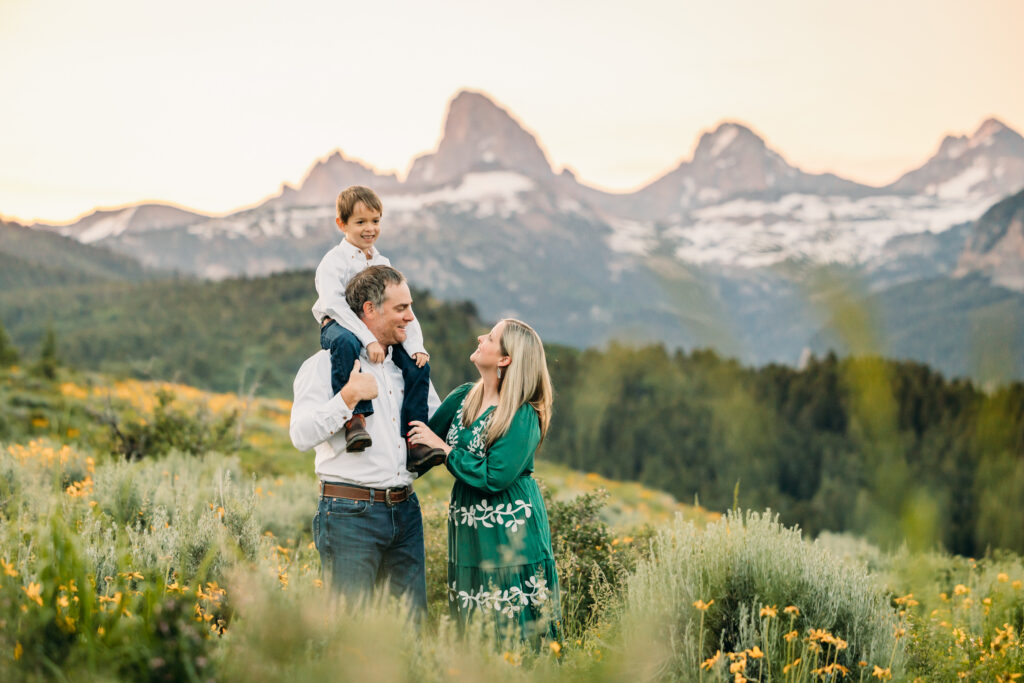 Grand Teton National Park family photographer capturing soft morning light over the mountains and a joyful family.