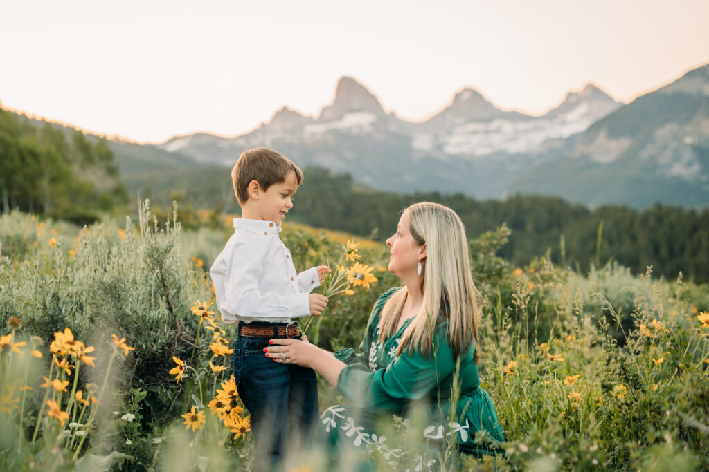 Grand Teton National Park family photographer capturing soft morning light over the mountains and a joyful family.