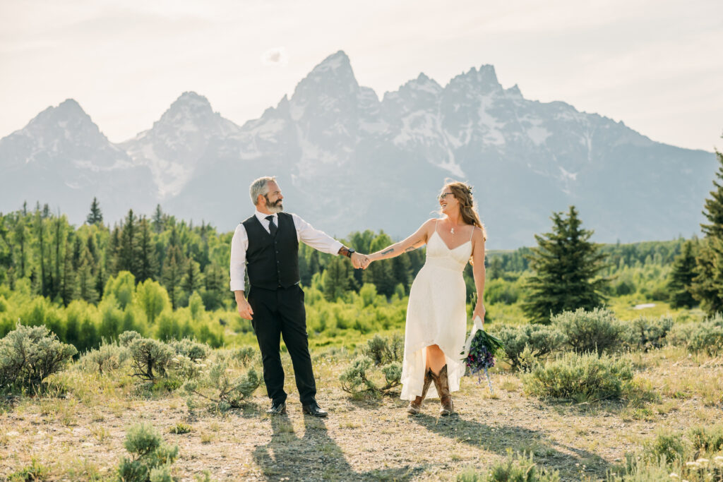 Bride and groom laughing during adventurous Grand Teton National Park elopement