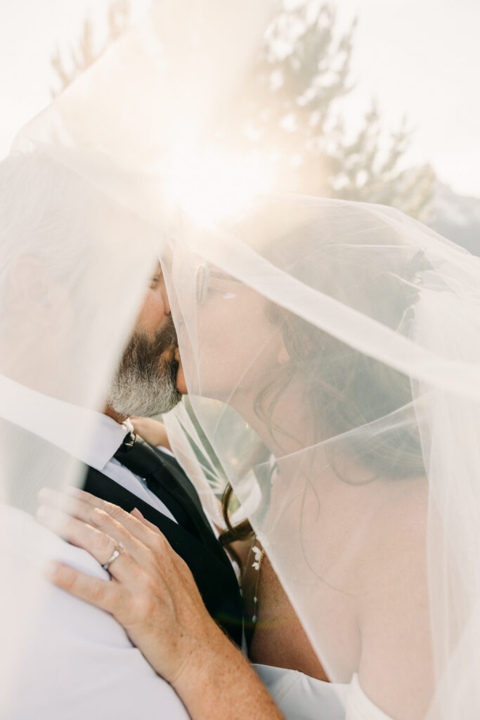 Bride and groom laughing during adventurous Grand Teton National Park elopement
