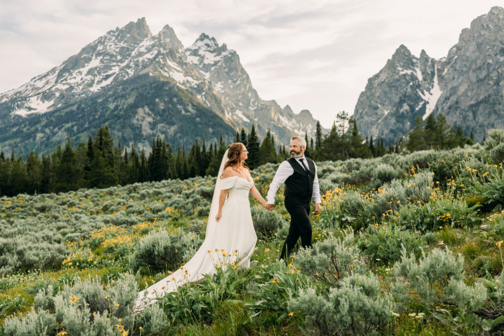 Bride and groom laughing during adventurous Grand Teton National Park elopement