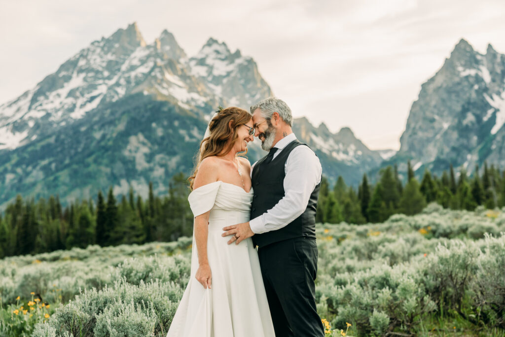 Bride and groom laughing during adventurous Grand Teton National Park elopement