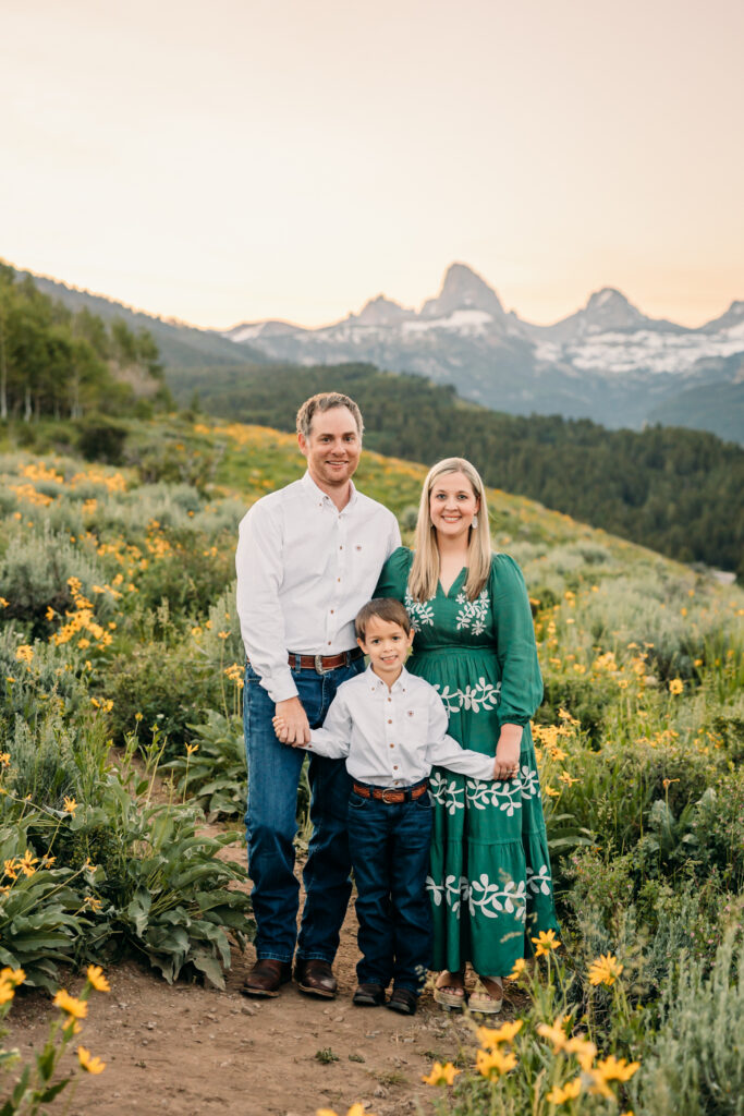 Grand Teton National Park family photography session featuring parents and son framed by the Teton mountain range.