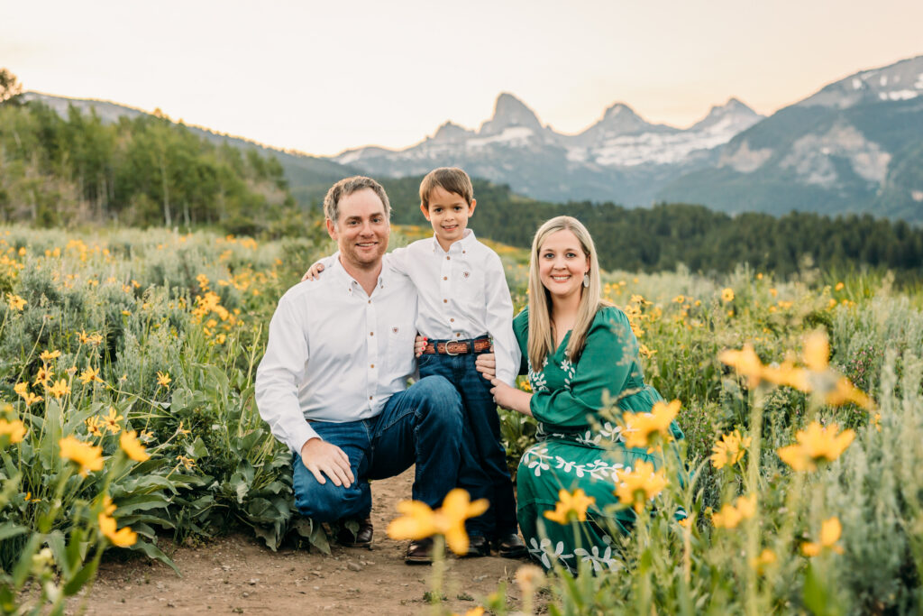 Grand Teton National Park family photography session featuring parents and son framed by the Teton mountain range.