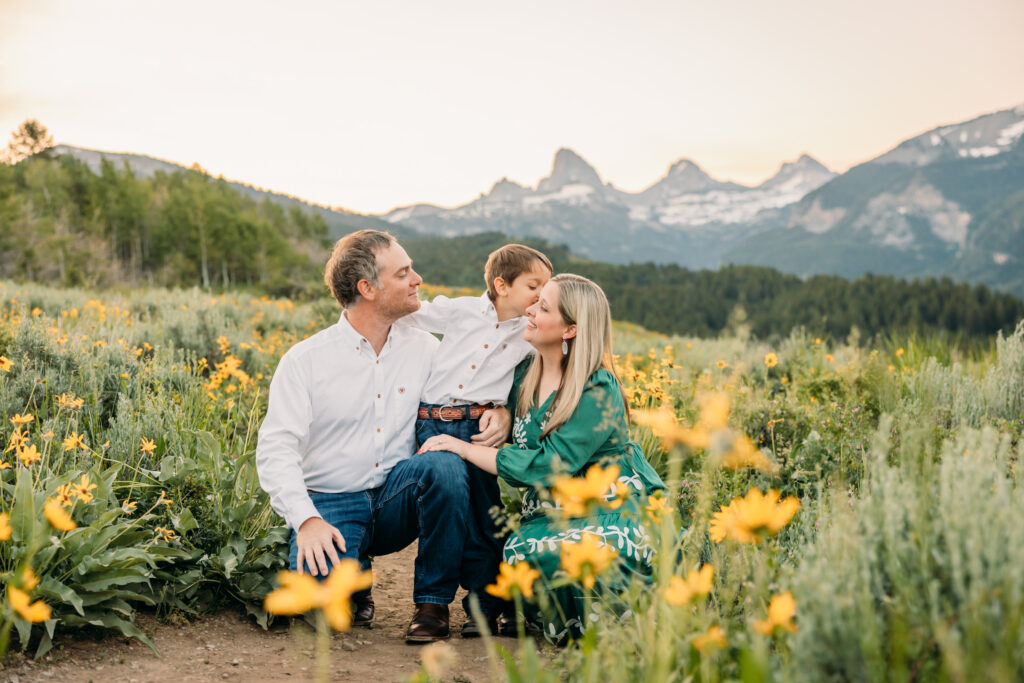 Grand Teton National Park family photography session featuring parents and son framed by the Teton mountain range.