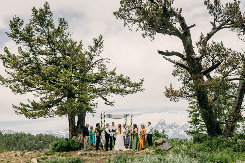 Jewish Bride and groom exchanging vows beneath The Wedding Tree overlooking the Tetons in Grand Teton National Park