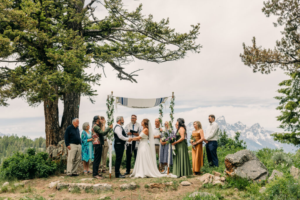 Jewish Bride and groom exchanging vows beneath The Wedding Tree overlooking the Tetons in Grand Teton National Park