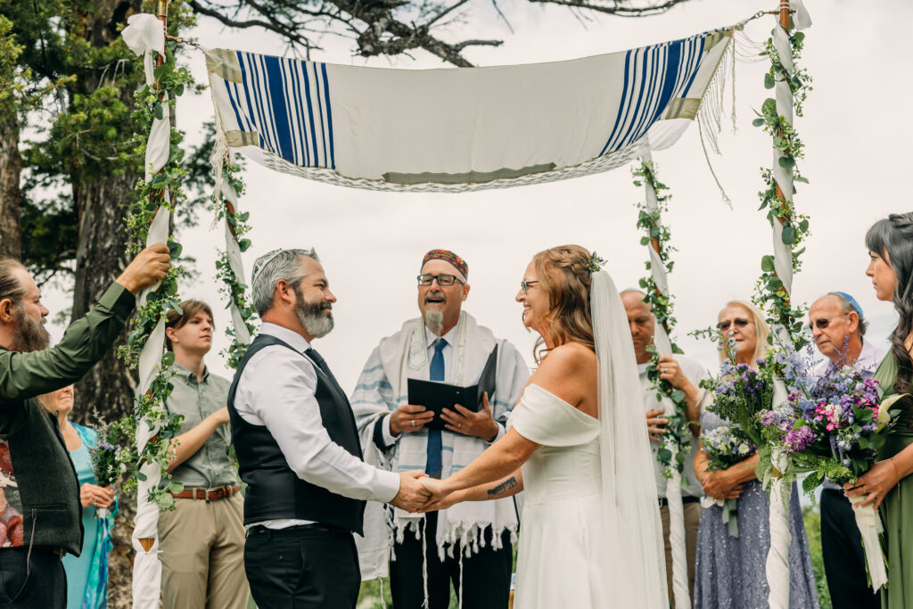 Jewish Bride and groom exchanging vows beneath The Wedding Tree overlooking the Tetons in Grand Teton National Park