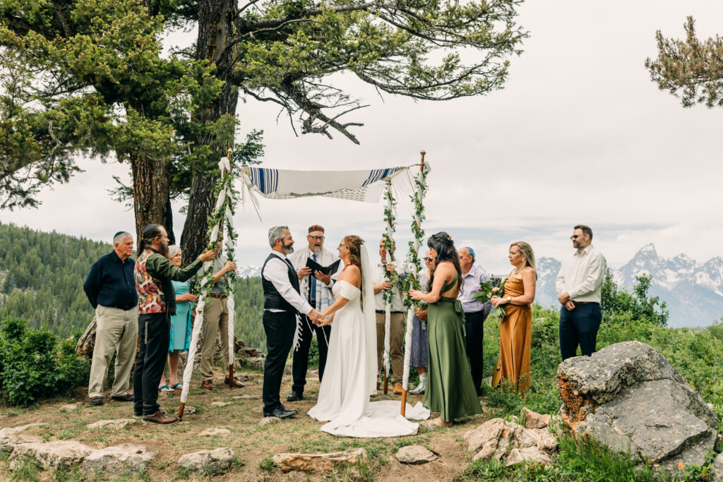 Jewish Bride and groom exchanging vows beneath The Wedding Tree overlooking the Tetons in Grand Teton National Park