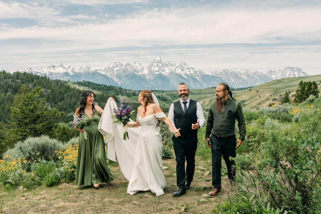 Bride and groom exchanging vows beneath The Wedding Tree overlooking the Tetons in Grand Teton National Park