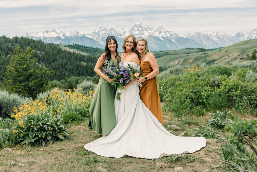 Bride and groom exchanging vows beneath The Wedding Tree overlooking the Tetons in Grand Teton National Park