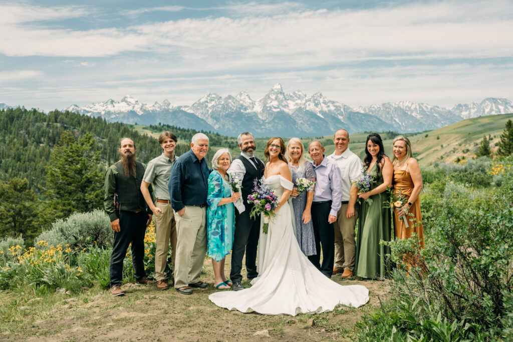 Bride and groom exchanging vows beneath The Wedding Tree overlooking the Tetons in Grand Teton National Park