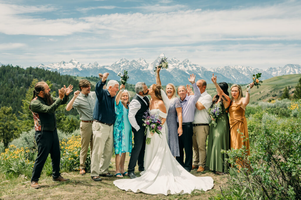 Bride and groom exchanging vows beneath The Wedding Tree overlooking the Tetons in Grand Teton National Park