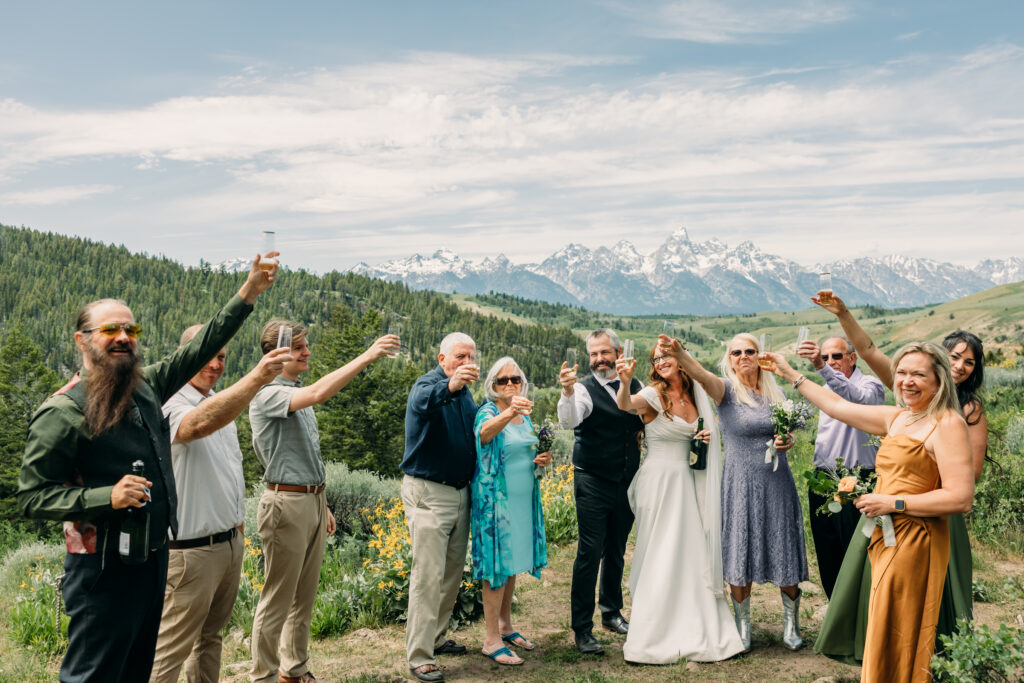 Bride and groom exchanging vows beneath The Wedding Tree overlooking the Tetons in Grand Teton National Park