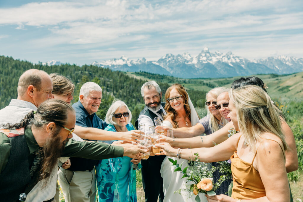 Bride and groom exchanging vows beneath The Wedding Tree overlooking the Tetons in Grand Teton National Park