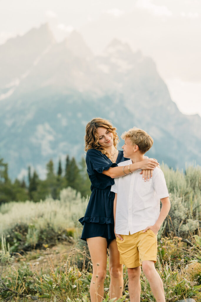 Family portraits with scenic Wyoming mountain backdrop at Cascade Canyon Turnout in Grand Teton National Park at sunset