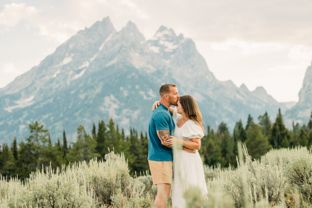 Family portraits with scenic Wyoming mountain backdrop at Cascade Canyon Turnout in Grand Teton National Park at sunset