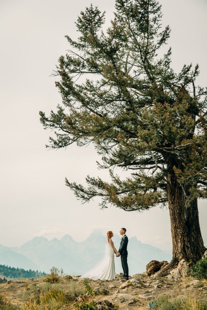 Eloping couple with the Teton mountain range in Grand Teton National Park