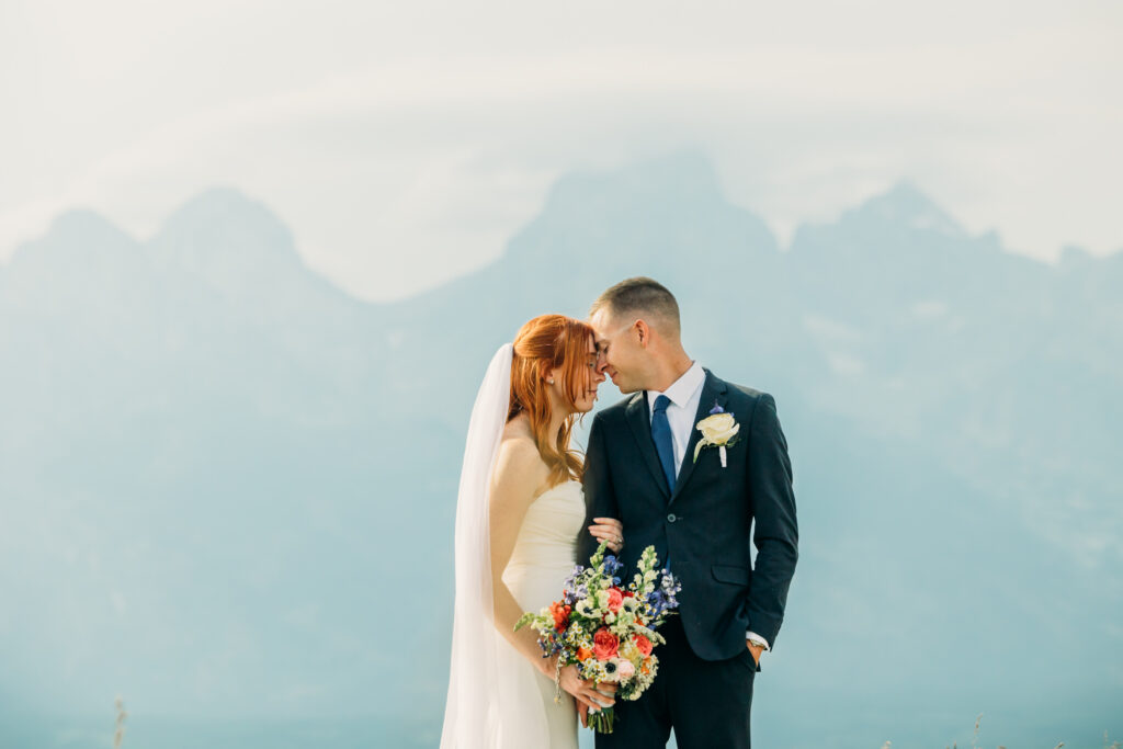 Bride and groom celebrating their Jackson Hole elopement with mountain views