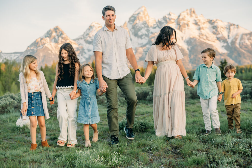 Sunrise at Grand Teton National Park family photo session family walking towards camera