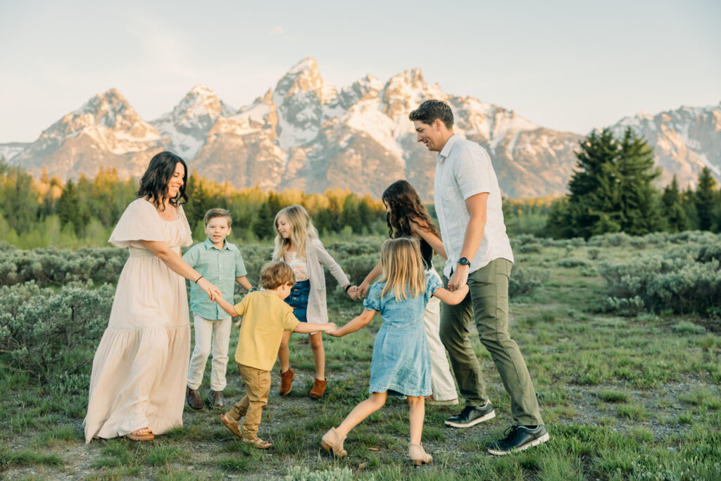 Sunrise at Grand Teton National Park family photo session family walking towards camera