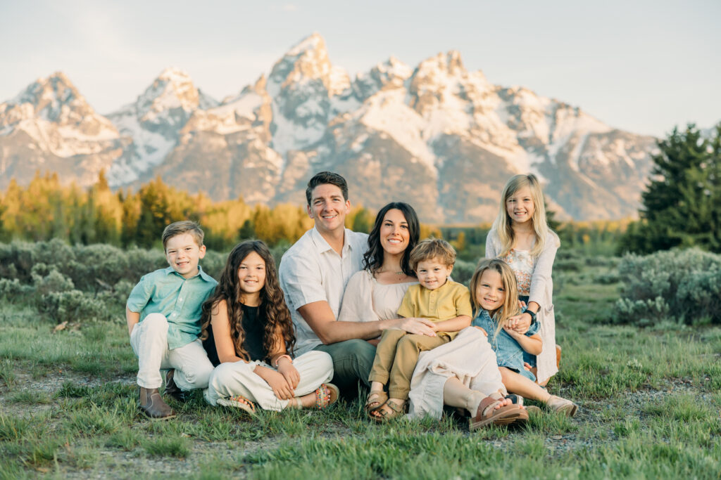 Grand Teton National Park family photo session family sitting down in meadow