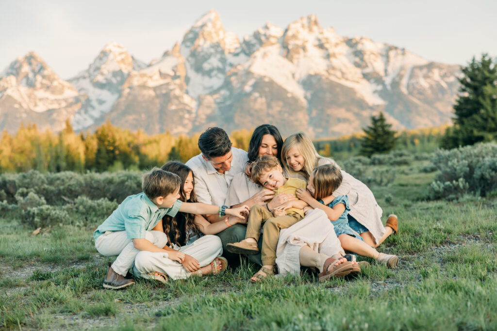 Grand Teton National Park family photo session family sitting down in meadow