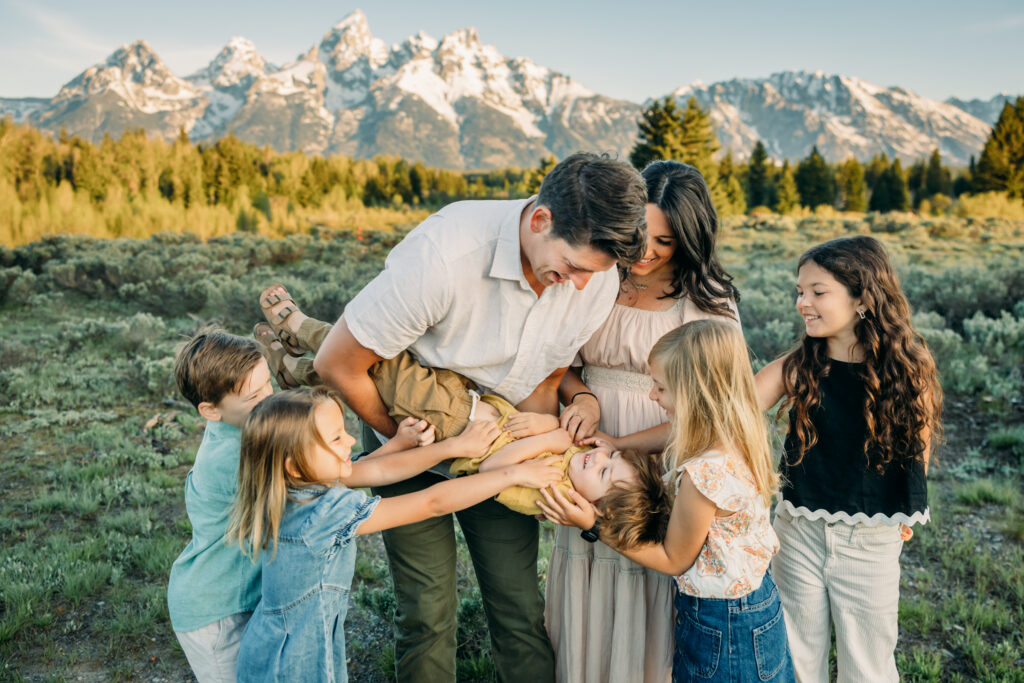 Grand teton family photographer tickling fight