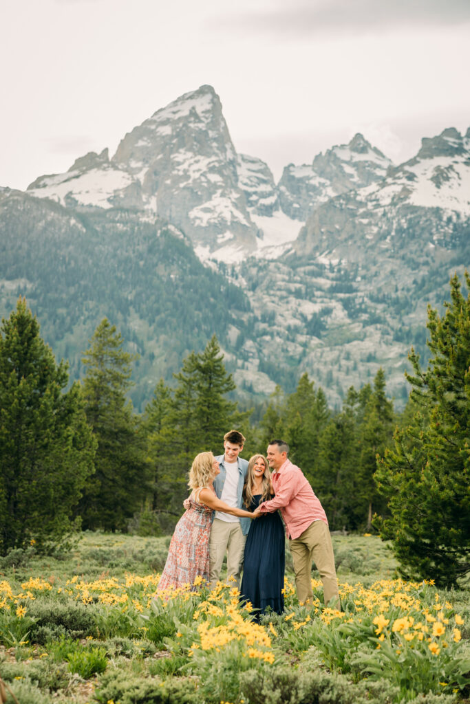 Sunset family photos with the Teton mountains in Grand Teton National Park in June with the sunflowers